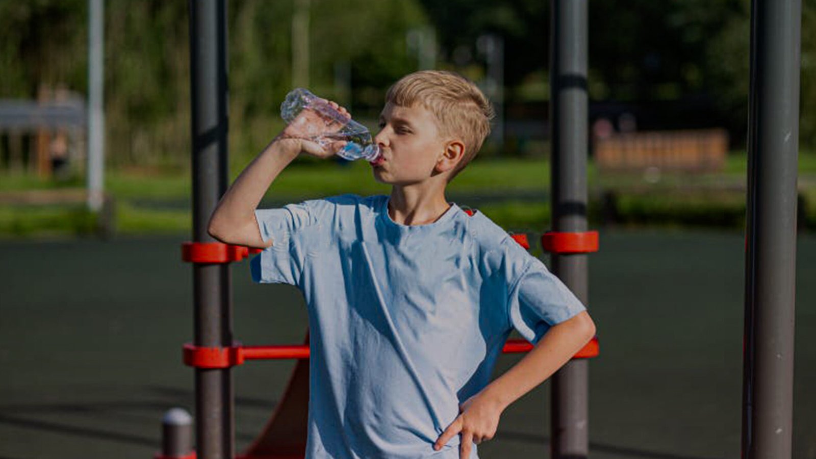 youth wrestler drinking water